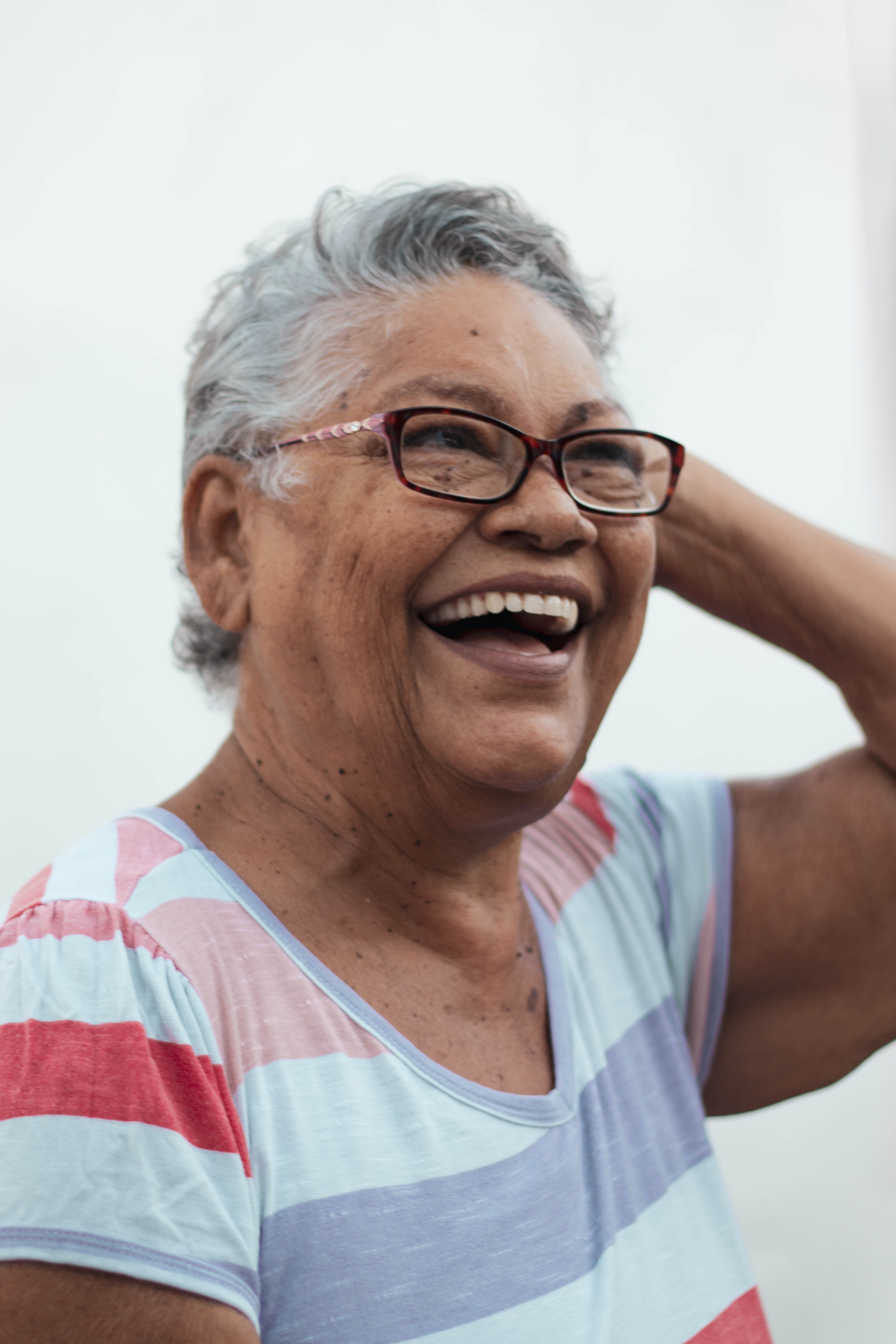 woman with glasses laughing